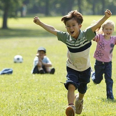 smiling-children-running-playing-soccer summer oral health tips from bellevue dentists