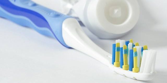 blue-toothbrush-with-toothpaste-tube oral hygiene instruments from your bellevue family dentist